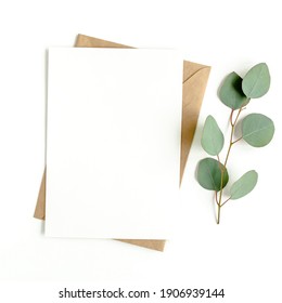 Mockup invitation, blank greeting card and green leaves eucalyptus. Flat lay, top view. - Powered by Shutterstock