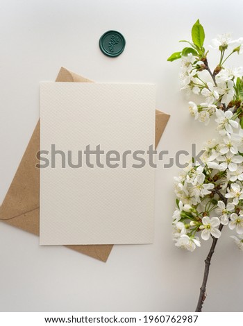 Mockup invitation, blank paper greeting card, floral background, flat lay