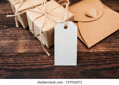 Mockup Kraft Gift Boxes With Tag On Wooden Background