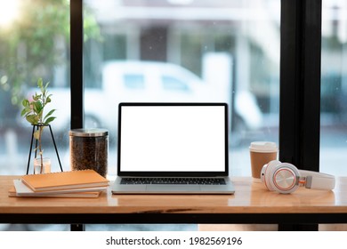 Mockup Laptop Computer With Blank White Screen And Coffee, Book On Cafe Table