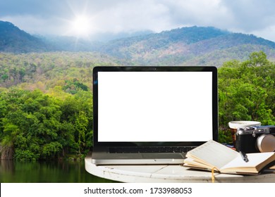 Mockup Of Laptop Computer With Empty Screen With Camera,notebook,coffee Cup On Table At Landscape Lake Views Nature Forest Mountain Views Spring With White Cloud Background,Freelance Work And Holiday