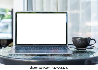 Mockup of laptop computer with empty screen with coffee cup and smartphone on table of the coffee shop outdoor background,White screen - Shutterstock ID 2191062237