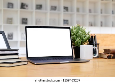 Mockup Laptop Computer On Wooden Table With Library Background.