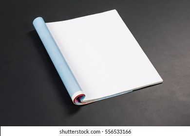 Mock-up magazine or catalog on black chalkboard. Blank page or notepad on black table background. Blank page or notepad for mockups or simulations. - Shutterstock ID 556533166