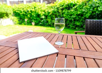 Mockup Of A Magazine Cover On A Wooden Table In The Garden In Summer.