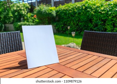 Mockup Of A Magazine Cover On A Wooden Table In The Garden In Summer.