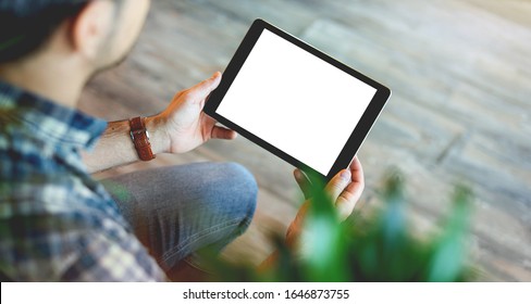 Mockup Of A Man Holds Tablet Computer With Isolated Screen In His Hands. View From Above. Clipping Path.