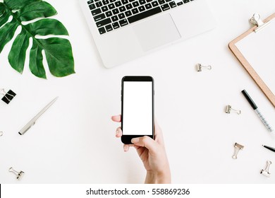 Mockup Of Mobile Phone With Blank Copy Space Screen In Female Hand. Flat Lay, Top View Workspace