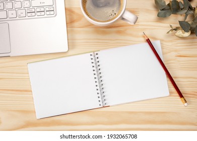 mockup notepad Notebook and coffee on wooden background, top view with space for text on workplace. top view. Blank sketchbook on wooden desk background