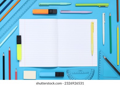 Mockup open notepad with stationery on a blue background. Top view, flat lay. Diary for entries, copy space. Open notebook with space for text with colorful school supplies