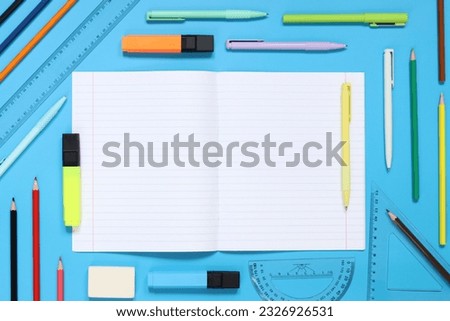 Mockup open notepad with stationery on a blue background. Top view, flat lay. Diary for entries, copy space. Open notebook with space for text with colorful school supplies
