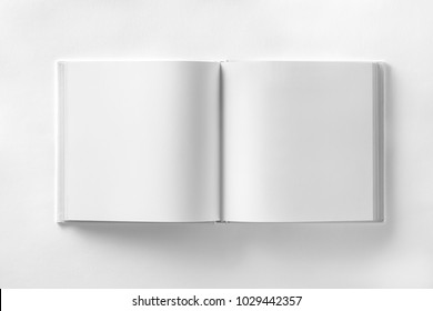 Mockup of opened blank square book at white design paper background. - Shutterstock ID 1029442357