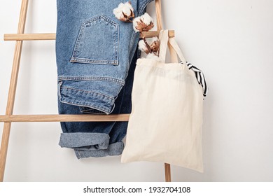 Mockup with organic cotton tote bag and jeans. Sustainable ethical consumption, zero waste, circular fashion concept