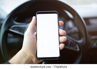 Mockup Of Phone In Hand On Blurred Car Background