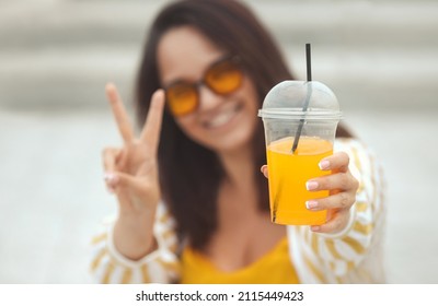 Mockup Photo Of Happy Millennial Plus Size Woman 30-35 Years Old Smiling With White Teeth Holding Takeaway Drink In Platic Cup Of Juicy Coctail In Summer Day