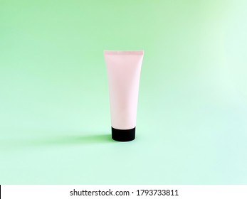 Mock-up Of Pink Squeeze Bottle Plastic Tube With Black Cap On Green Background. Bottle For Branding And Label. Natural Organic Spa Cosmetics Concept. Trendy Shadow