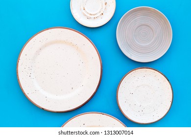 Mockup with plates. Empty ceramic plates on blue background top view