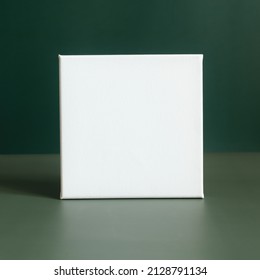 Mockup Poster. Blank Square Canvas Frame On Minimalistic Dark Green Background.