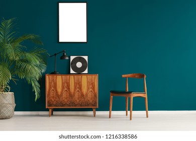 Mockup Poster On Pine Green Wall In Scandinavian Minimal Interior With Retro Furniture And Plant, Real Photo