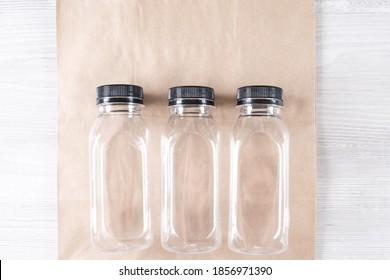 Mockup, Scene Creator. Paper Bag, Three Plastic Bottles. Eco-friendly Food Packaging And Cotton Eco Bags On Gray Background With Copy Space. Containers For Catering And Street Fast Food