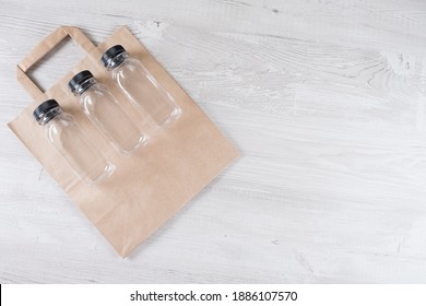 Mockup, Scene Creator. Paper Bag, Three Plastic Bottles. Eco-friendly Food Packaging And Cotton Eco Bags On Gray Background With Copy Space. Containers For Catering And Street Fast Food