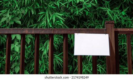 Mockup Of Sign On Fence With Bamboo Wood Forest, Natural Background. Layout Mock Up Of Protected Area Ready For Your Design Preview. Billboard Mock-up With Copy Space For Logo Design Presentation.