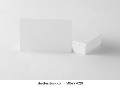 Mockup Of Single White Business Card At Cards Stack At White Design Paper Background.