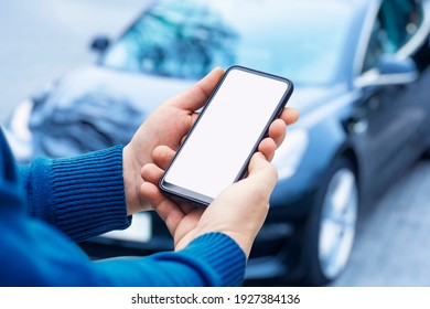 Mock-up of a smartphone in the hands of a man against the background of a car - Powered by Shutterstock