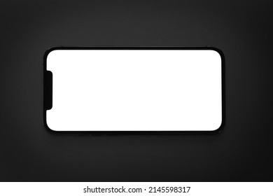 Mockup Smartphone IPhone Horizontal With White Screen, Empty Display In The Dark. Apple Is A Multinational Technology Company. Batumi, Georgia - March 19, 2022