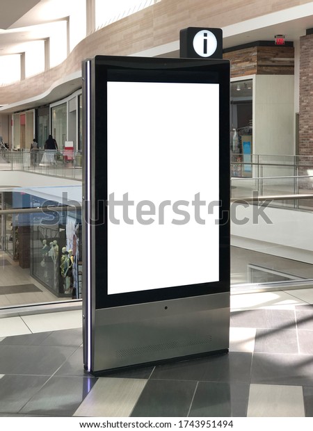 Mockup standalone big screen info kiosk. Digital\
media with blank white screen modern panel, display, signboard for\
advertisement design in a shopping center and mall. Including\
clipping path.