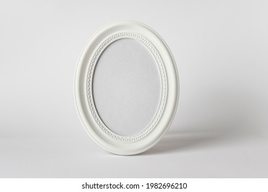 Mockup template with round oval standing photo frame on white background.