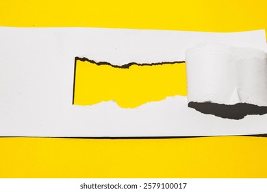 mockup of a torn white paper revealing a vibrant yellow background. Perfect for showcasing your brand, logo, or text.