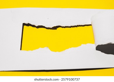 mockup of a torn white paper revealing a vibrant yellow background. Perfect for showcasing your brand, logo, or text.