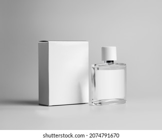 Mockup Of A Transparent Glass Bottle For Perfume, With A Label For Design, A White Cardboard Box For A Branded Scent, Fragrance. Cosmetics Advertising Containers Template Isolated On Background