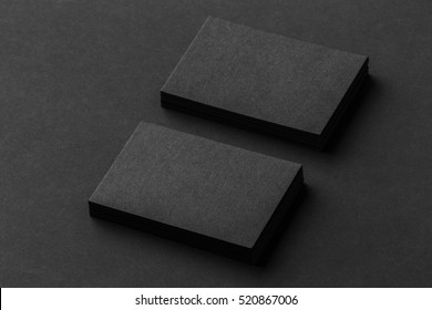 Mockup of two horizontal business cards at black textured background.