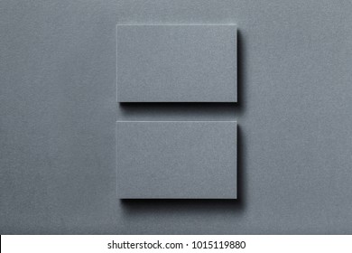 Mockup Of Two Horizontal Silver Metallic Business Card Stacks At Textured Designer Paper Background.