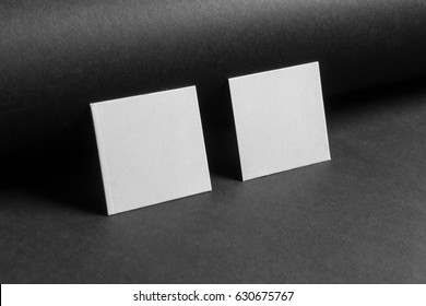 Mock-up of the two square business cards are on a black paper - Shutterstock ID 630675767
