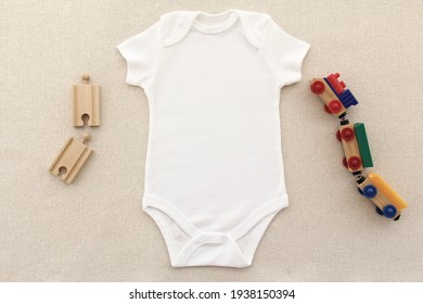 Mockup Of White Baby Bodysuit Shirt , Wooden Toy