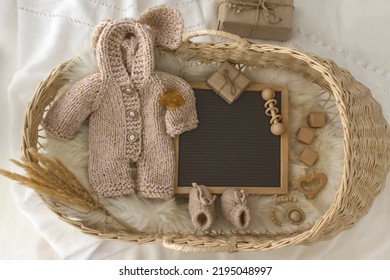 Mockup of white baby bodysuit shirt with basket, Winter Social Media Pregnancy Letter Board Announcement .Background with blurred . Selective focus