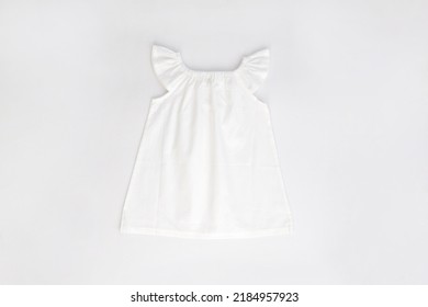 Mockup of white baby cotton dress on white background. Layout mock up ready for your design preview. 