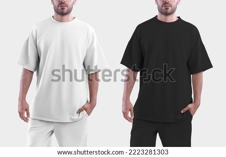 Mockup of a white and black oversize t-shirt on a man. Template isolated on white background.