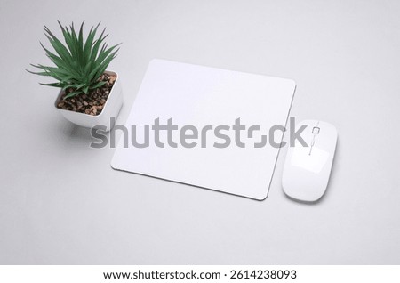 Mockup of white blank computer mouse pad or mat with wireless mouse on gray background