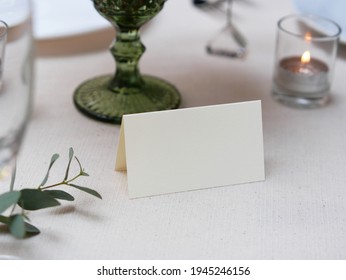 Mockup white blank space card, for Name place, Folded, greeting, invitation on wedding table setting background. with clipping path - Shutterstock ID 1945246156