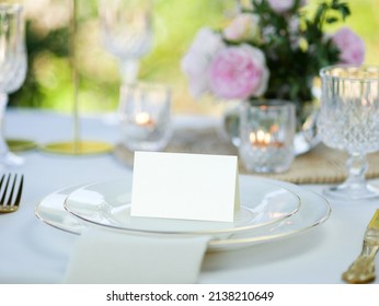 Mockup white blank space card, for Name place, Folded, greeting, invitation on wedding table setting background. with clipping path