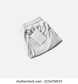 Mockup Of White Folded Shorts With Compression Lining, Price Tag Near Pocket, Front View. Men's Sportswear Template Isolated On Background