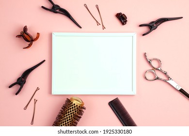 Mockup White Frame Of Professional Hair Cutting Shears Comb For Separating Hair Hairpins Section Hair Clips And Gold Round Hair Brush For Styling With Copy Space On Pink. Hairdresser Salon Equipment