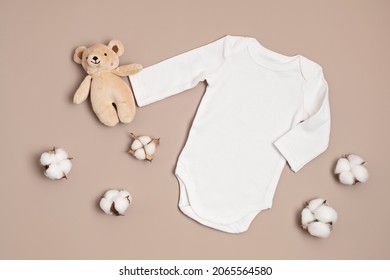 Mockup Of White Infant Bodysuit Made Of Organic Cotton With Eco Friendly Baby Toys. Onesie Template For Brand, Logo, Advertising. Flat Lay, Top View