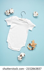 Mockup Of White Infant Bodysuit Made Of Organic Cotton With Eco Friendly Baby Accessories. Onesie Template For Brand, Logo, Advertising. Flat Lay, Top View