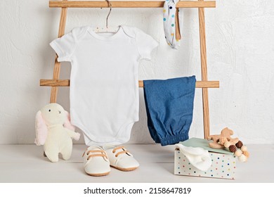 Mockup Of White Infant Bodysuit Made Of Organic Cotton With Eco Friendly Baby Accessories. Onesie Template For Brand, Logo, Advertising. Flat Lay, Top View