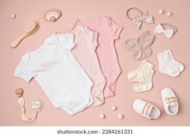 Mockup of white infant bodysuit made of organic cotton with eco friendly baby accessories. Onesie template for brand, logo, advertising. Flat lay, top view